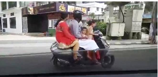Vídeo flagra menina de 5 anos pilotando moto com pais e irmão na garupa