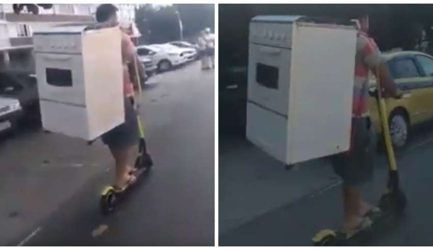 De patinete, homem transporta fogão nas costas e viraliza na web